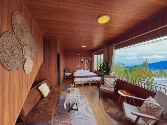Phòng P.201 nhìn từ cửa: sofa, giường và ghế ban công hướng núi